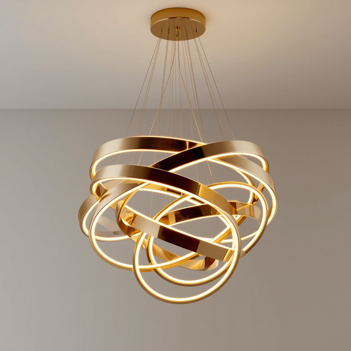 A modern gold interlocking rings LED chandelier hanging from a ceiling casting warm light across the fixture.