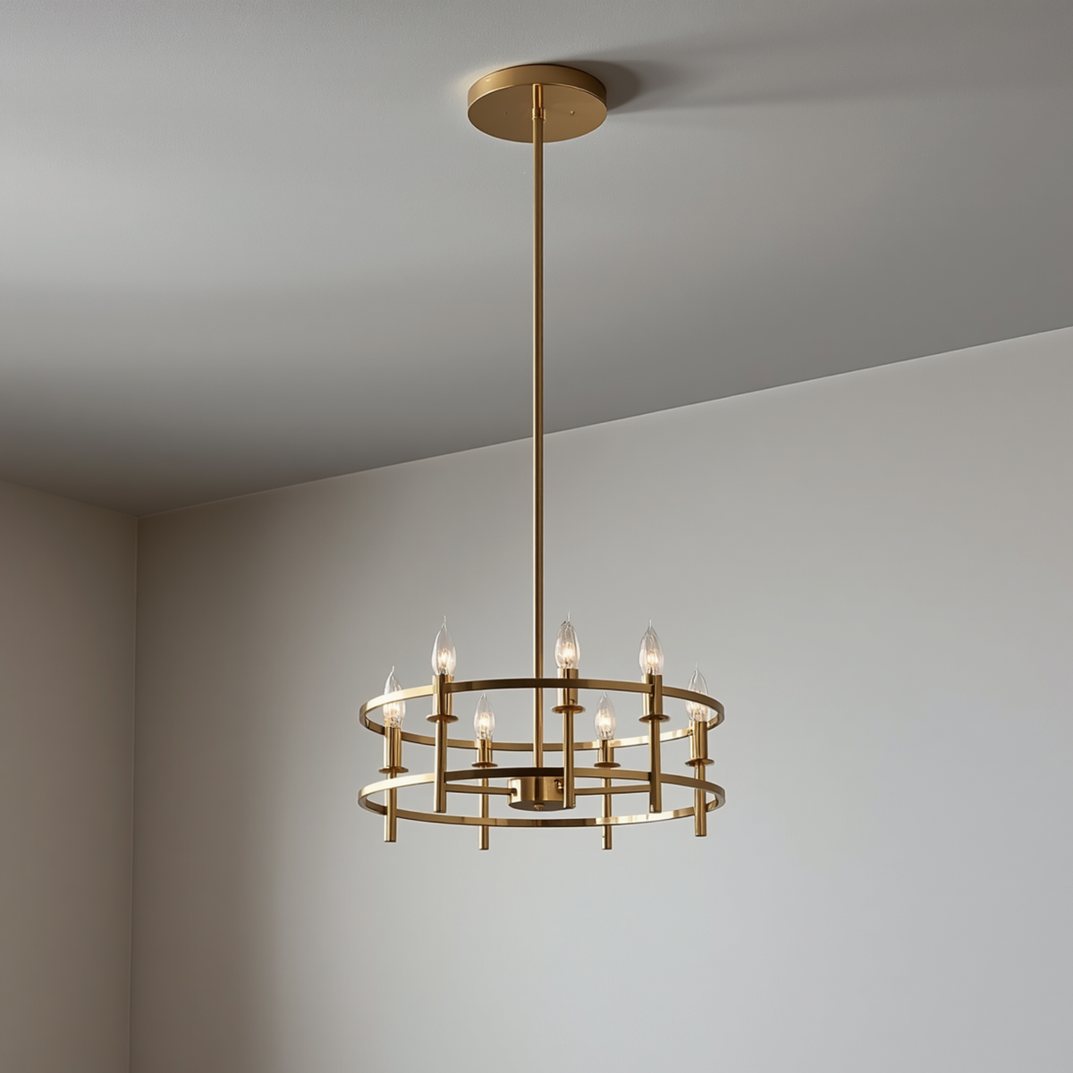 A modern gold dual-ring candelabra chandelier hanging from a ceiling with vertical support rods and candle-style bulbs.